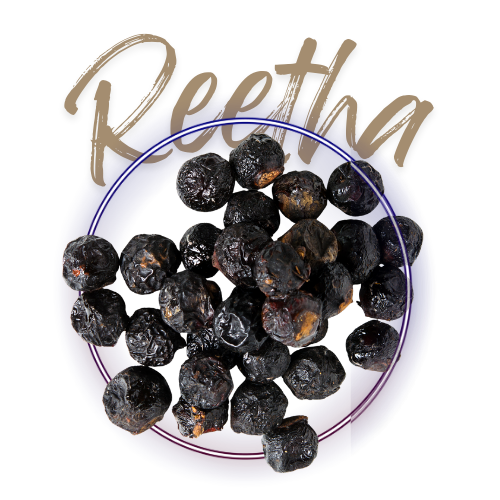 Black peppercorns in a glass bowl with 'Reetha' branding on a white background