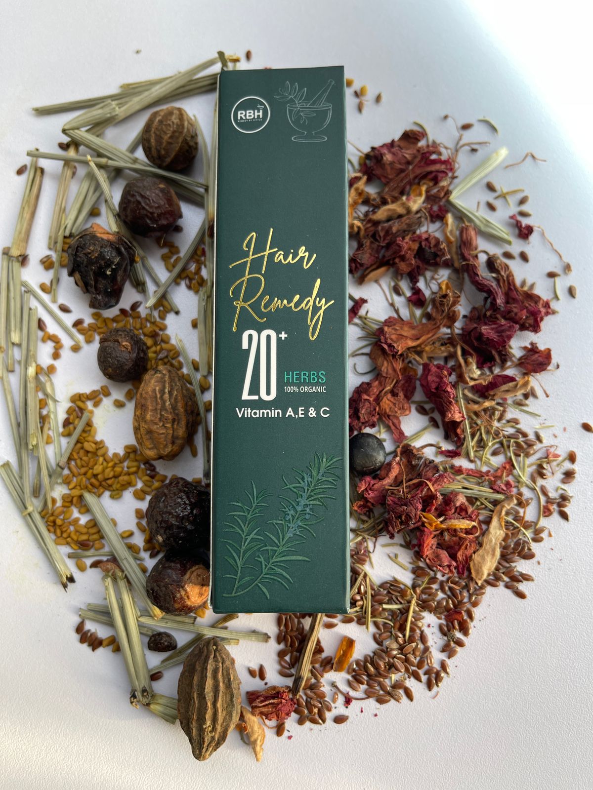 Hair Remedy packaging with herbs on a white background