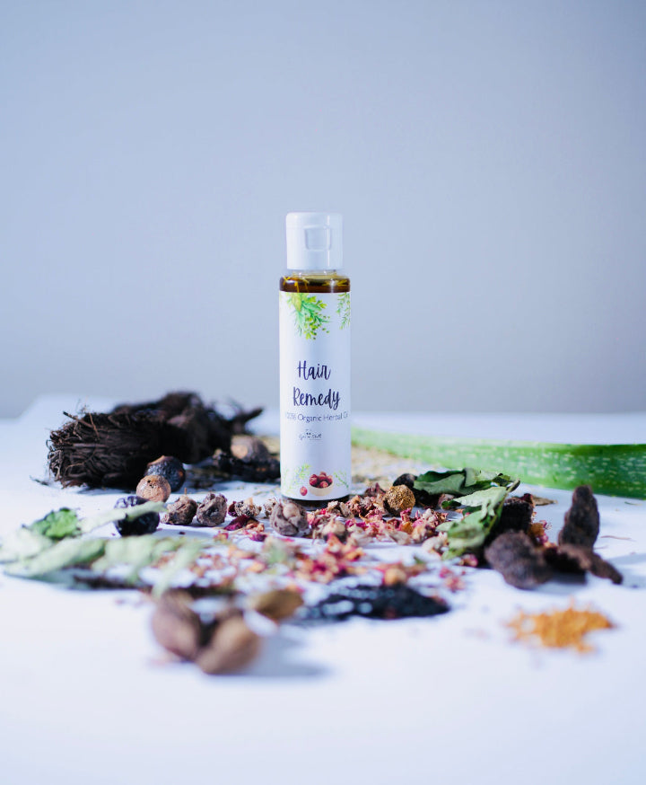 Hair remedy bottle with natural ingredients on a light background
