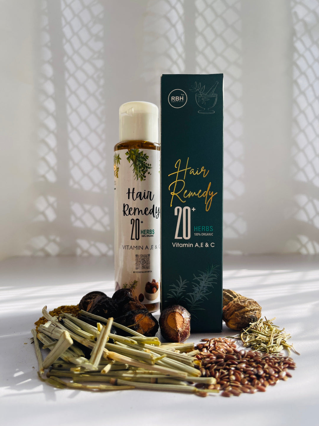 A plastic bottle, along with its box, containing oil made from herbal extracts.